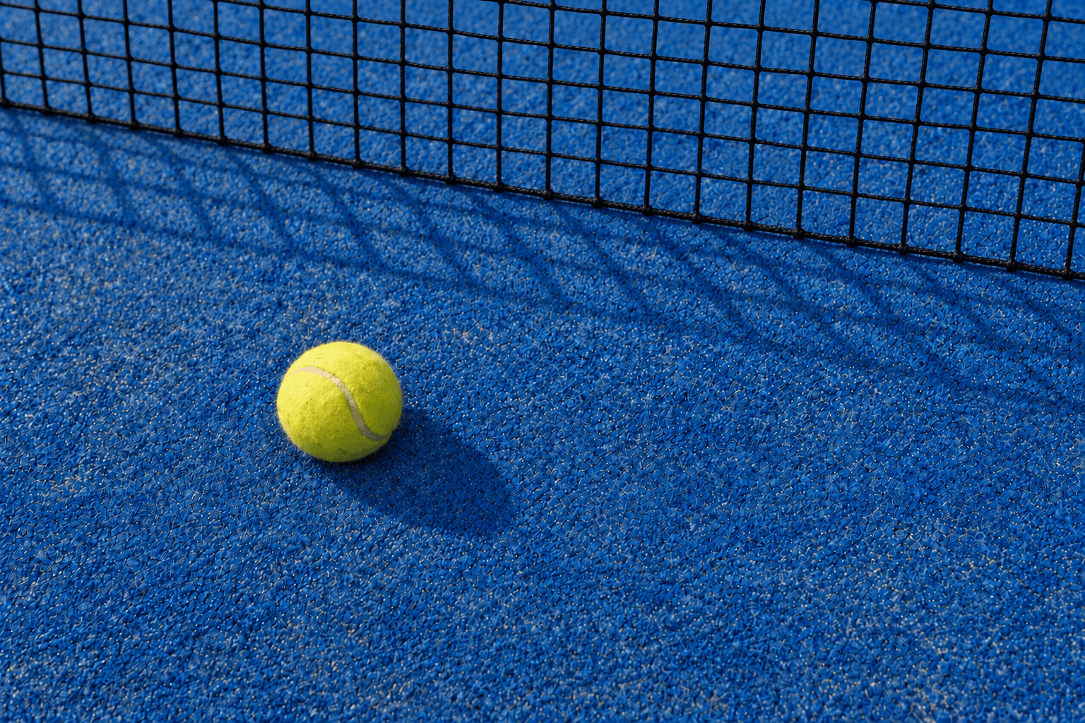 Padel court inside a glass enclosure at a club